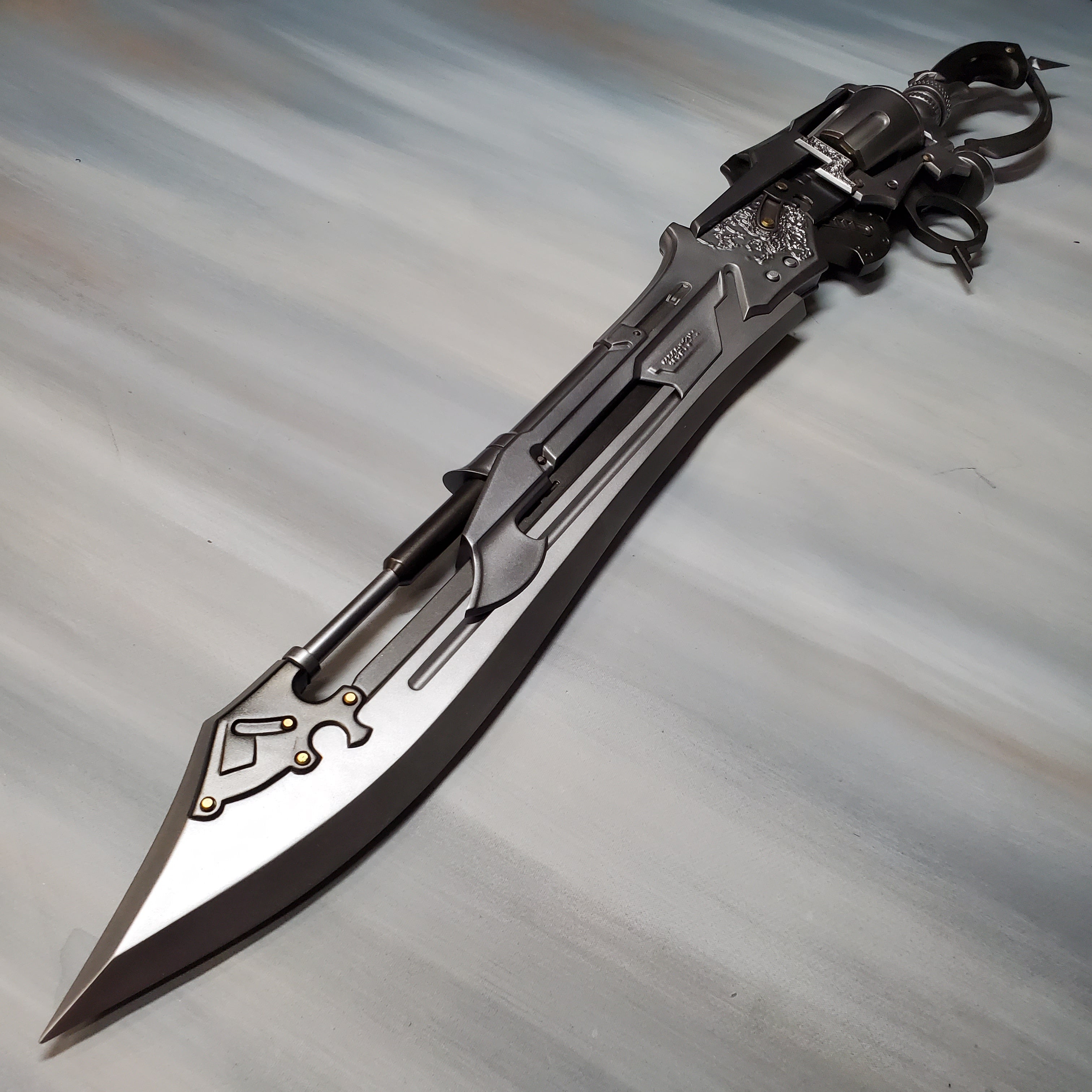 Decorative knife with intricate designs on a gray background