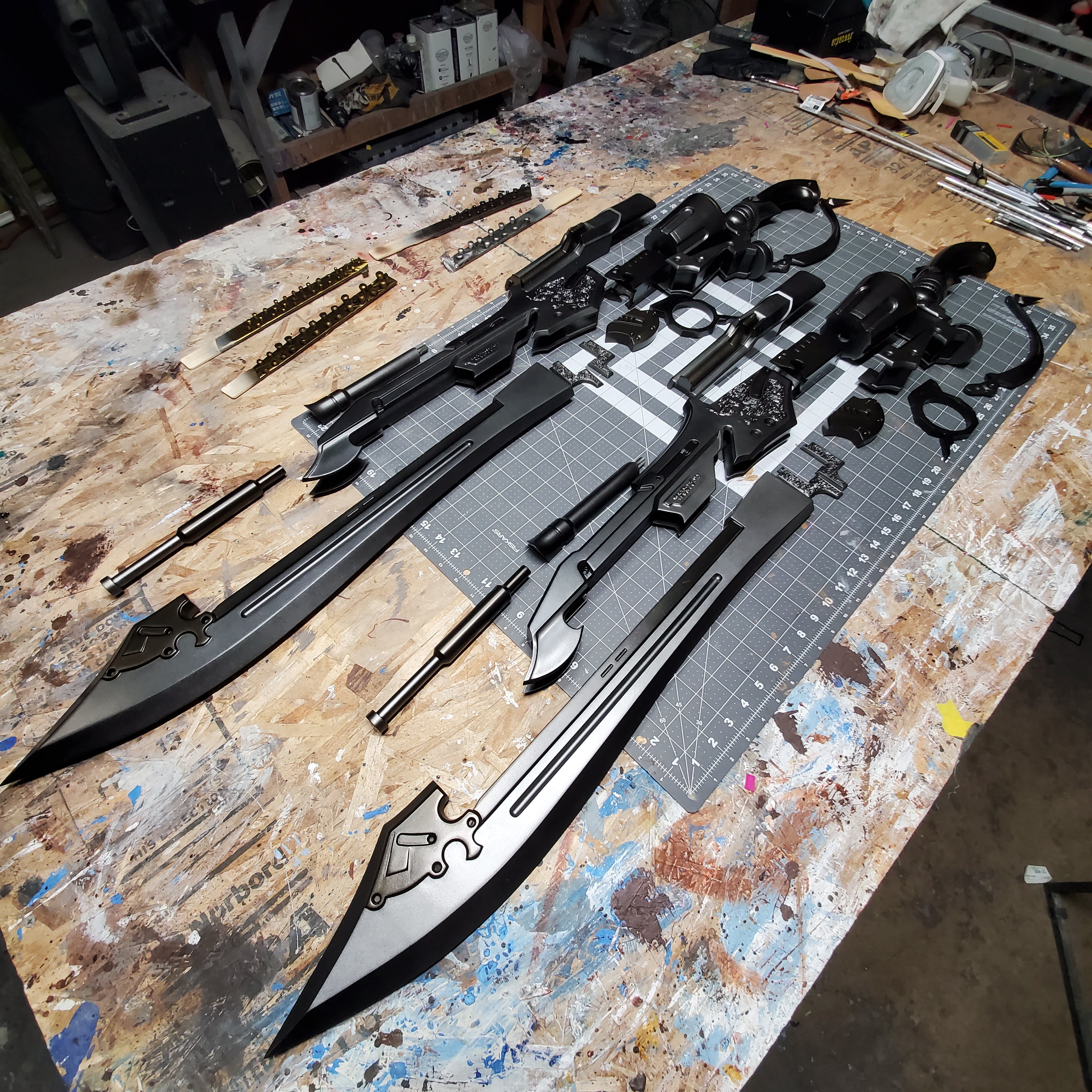 Long black sword with decorative elements on a workbench